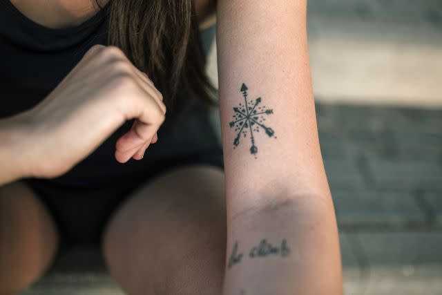 <p>Getty</p> A stock image of a person with a tattoo
