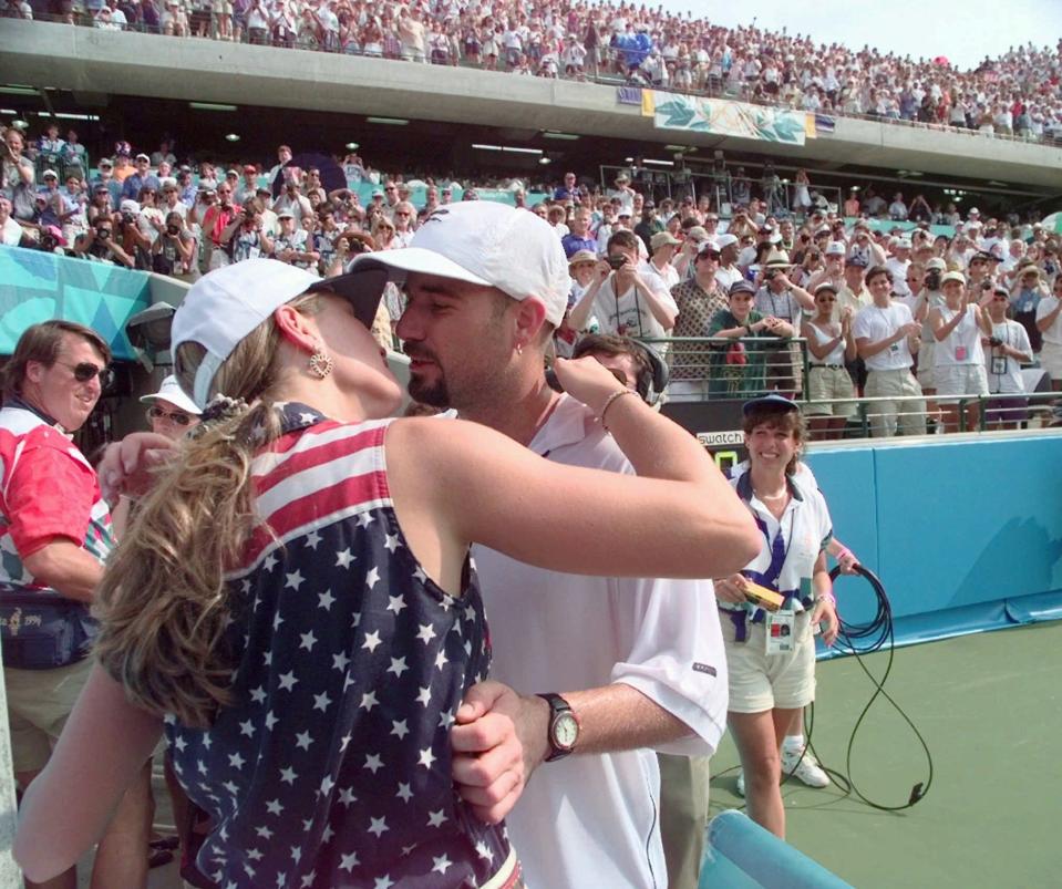 In this 1996 photo, Andre Agassi receives a congratulatory kiss from Brooke Shields after a tournament win. Shields and Agassi married in 1997 but divorced two years later.
