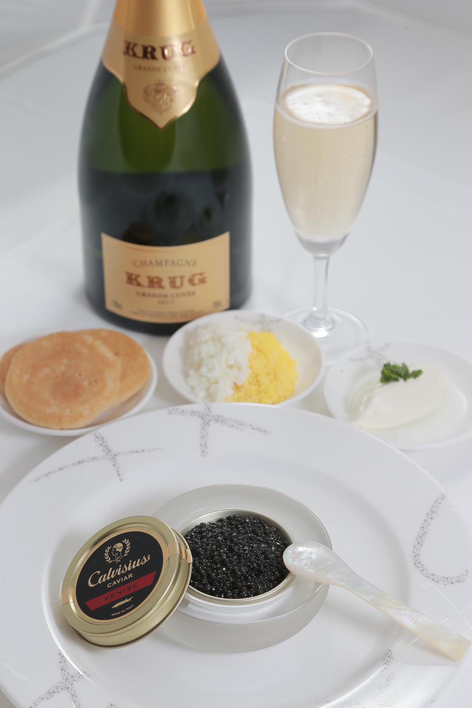 <b>Cathay Pacific</b><br>Cathay Pacific's First Class passengers are presented with a bespoke caviar and Krug service. Alongside warmed blinis, crème fraîche and chopped egg, the caviar is presented in a specially made glass caviar soccel and a mother-of-pearl spoon. That's a long way from a bag of pretzels.