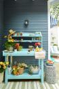 <p>Bring a wooden work bench outside, give it a coat of fresh paint and use it for, well, everything. When you're entertaining, turn it into a bar cart or serving station. Otherwise, let it become your catch-all spot for gardening tools, empty pots and watering cans. </p>