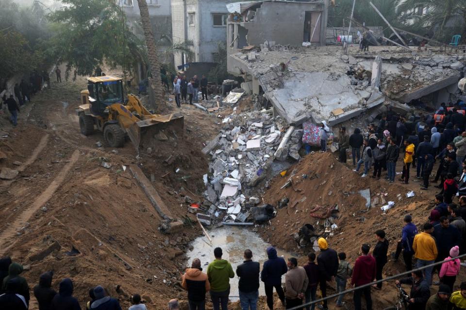 Palestinians search for survivors after an Israeli airstrike in Deir al Balah, Gaza Strip, Friday, Feb. 9, 2024.
