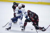 Ottawa Senators right wing Drake Batherson (19) looks on as teammate Brady Tkachuk collides with Toronto Maple Leafs defenseman Jake Muzzin (8) during the second period of an NHL hockey game in Ottawa, Ontario, Saturday, Jan. 16, 2021. (Adrian Wyld/The Canadian Press via AP)