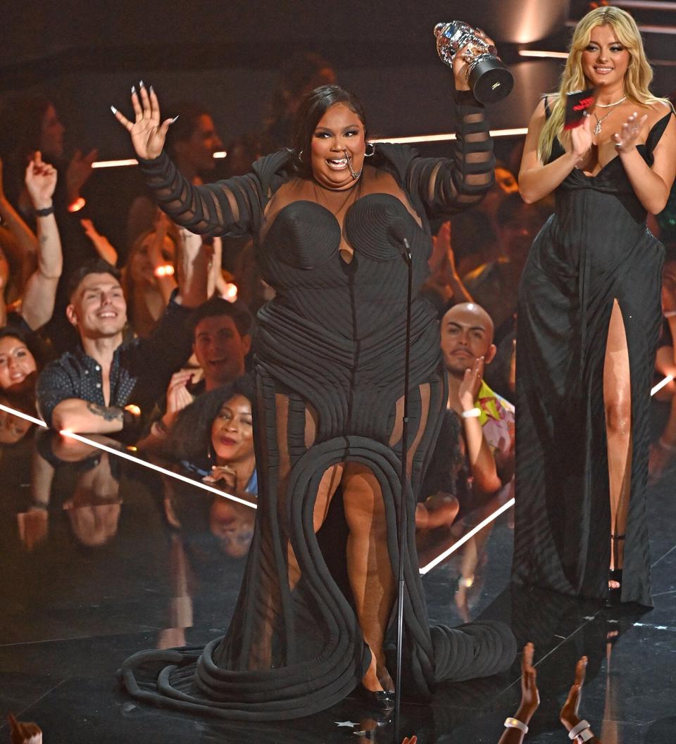 Lizzo accepts an award for Best Video for Good for "About Damn Time" from Bebe Rexha (right) on stage at the MTV Video Music Awards 2022