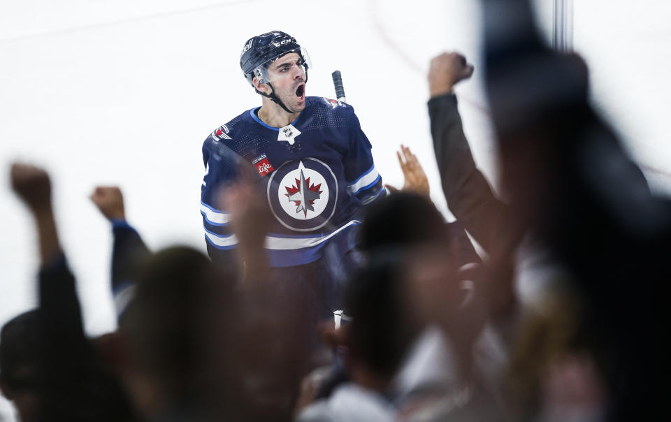 Winnipeg Jets' Dylan DeMelo (2) celebrates after his goal against the Florida Panthers during second-period NHL hockey game action in Winnipeg, Manitoba, Saturday, Oct. 14, 2023. (John Woods/The Canadian Press via AP)