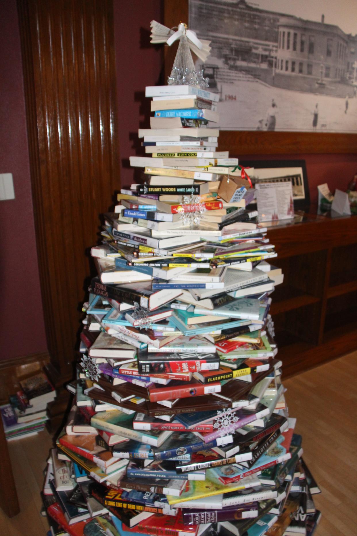 The Hometown Heritage and Perry Public Library's Festival of Trees entry features a tree made out of books at the Carnegie Library Museum. The Festival of Trees runs through Sunday, Jan. 8.