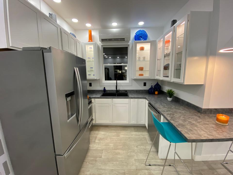 the kitchen with a fridge, countertop, the dining area, sink, storage