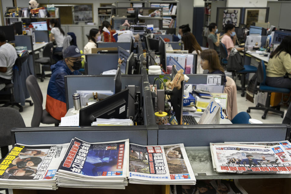 Reporters work at the news room of Apple Daily Monday, April 26, 2021, in Hong Kong. A year ago, the pro-democracy Apple Daily newspaper published a front-page headline saying Hong Kong's governing principle of “one country, two systems is dead." On Thursday, June 17, 2021, the newspaper was facing its greatest peril. Three top editors and two senior executives were arrested under Hong Kong's new national security law. (AP Photo/Vincent Yu)