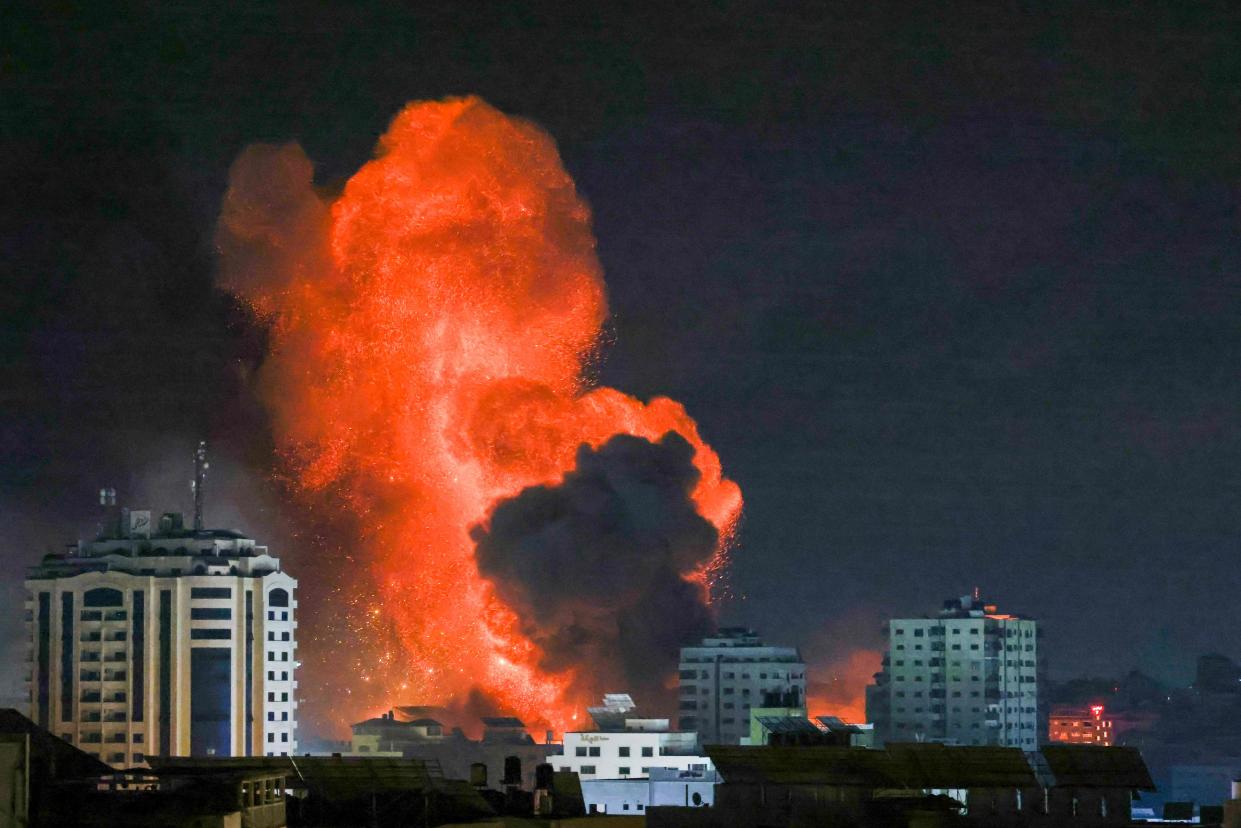 A fireball erupts from an Israeli airstrike in Gaza City on 9 October 2023 (AFP via Getty Images)