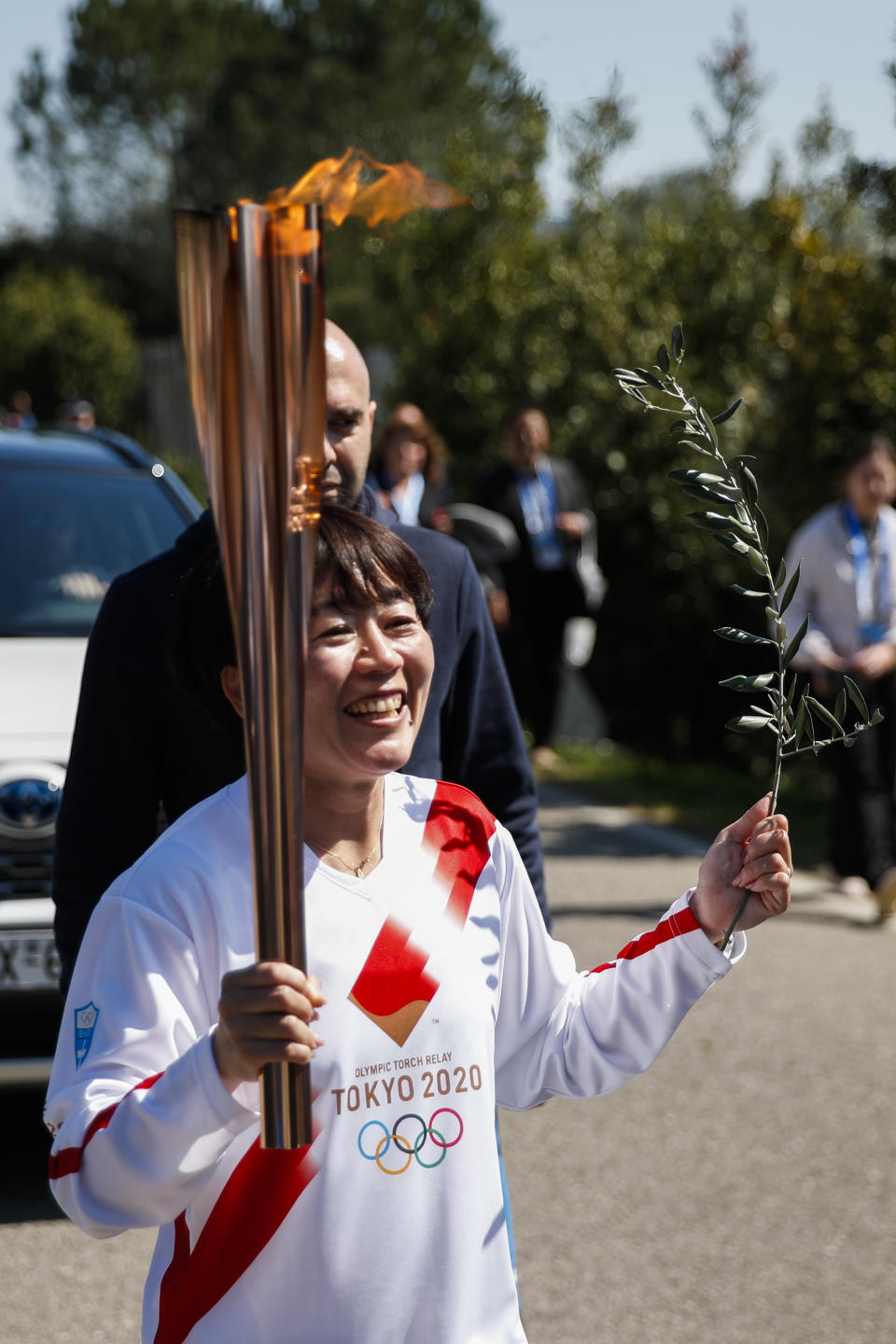 Japanese Olympic marathon champion, Mizuki Noguch, the second torchbearer, holds the torch following the flame lighting ceremony at the closed Ancient Olympia site, birthplace of the ancient Olympics in southern Greece, Thursday, March 12, 2020, 2020. Greek Olympic officials are holding a pared-down flame-lighting ceremony for the Tokyo Games due to concerns over the spread of the coronavirus. Both Wednesday's dress rehearsal and Thursday's lighting ceremony are closed to the public, while organizers have slashed the number of officials from the International Olympic Committee and the Tokyo Organizing Committee, as well as journalists at the flame-lighting. (AP Photo/Thanassis Stavrakis)