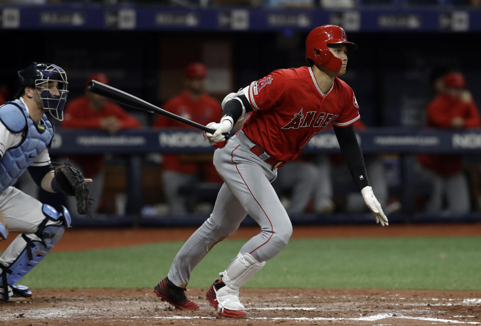 Los Angeles Angels' Shohei Ohtani, of Japan, watches his triple off Tampa Bay Rays' Ryan Yarbrough during the fifth inning of a baseball game Thursday, June 13, 2019, in St. Petersburg, Fla. Catching for the Rays is Mike Zunino. (AP Photo/Chris O'Meara)
