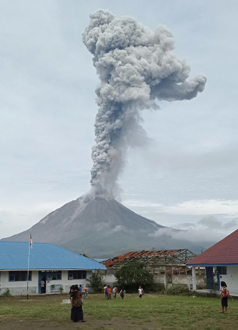 Mount Sinabung releases volcanic materials during an eruption as seen from a school yard in Karo, North Sumatra, Indonesia, Friday, May 7, 2021. Sinabung is among more than 120 active volcanoes in Indonesia, which is prone to seismic upheaval due to its location on the Pacific "Ring of Fire," an arc of volcanoes and fault lines encircling the Pacific Basin. (AP Photo/Sastrawan Ginting)