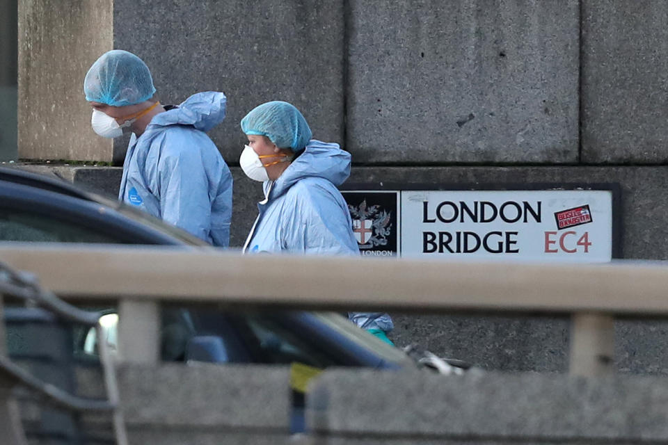 Forensic personnel on London Bridge in central London after a terrorist wearing a fake suicide vest who went on a knife rampage killing two people, was shot dead by police.