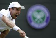 Spain's Roberto Bautista Agut serves to Argentina's Guido Pella during a men's quarterfinal match on day nine of the Wimbledon Tennis Championships in London, Wednesday, July 10, 2019. (AP Photo/Ben Curtis)