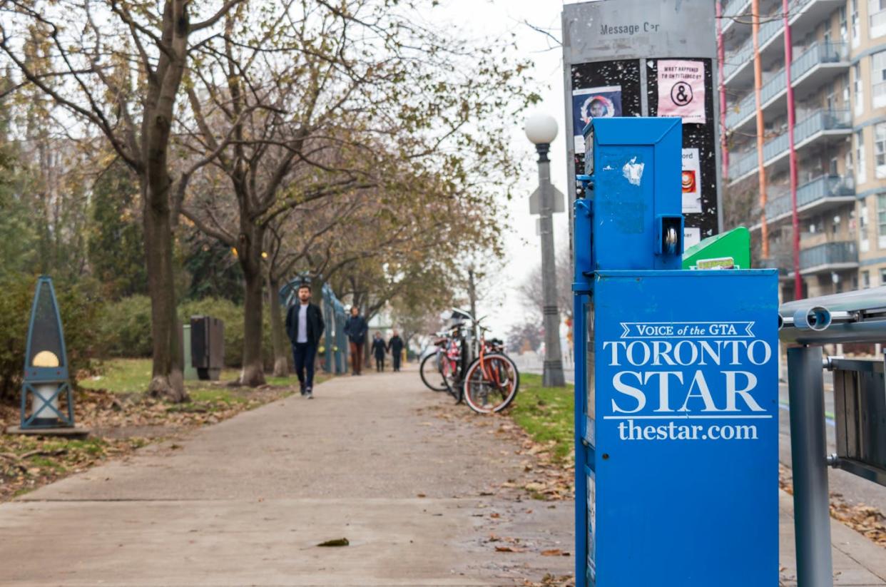 A 'Toronto Star' newspaper vending machine is seen on a busy sidewalk in downtown Toronto in November 2019. (Shutterstock)