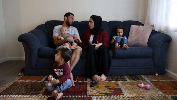 PHOTO: The Mohammadi family, Najib holding Yusuf, Yasar, Susan and Zahra, sit together in their living room, at their home in Sacramento, Calif., Aug. 1, 2022. (Brittany Hosea-Small/Reuters)