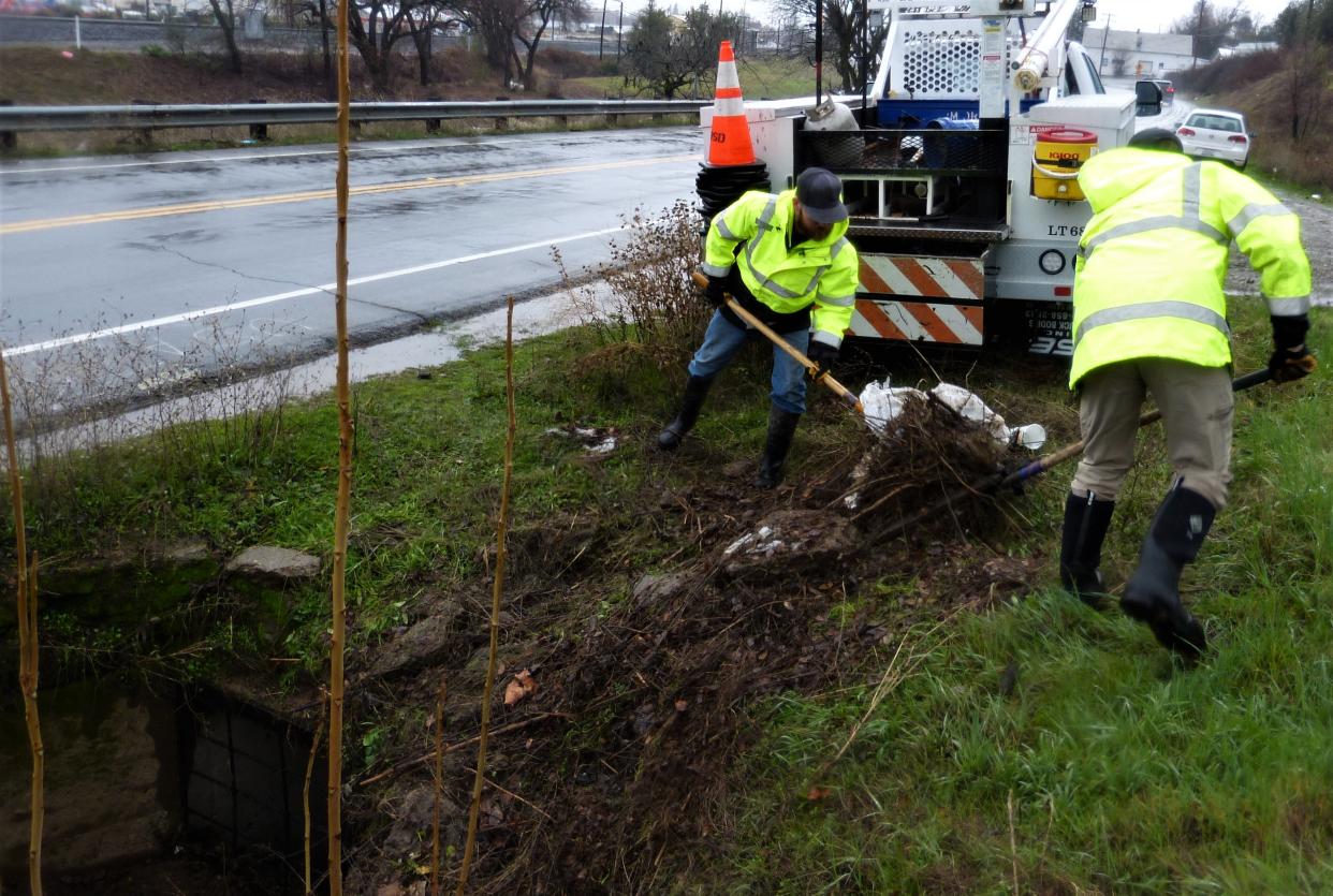 A city of Redding Public Works Department crew cleans out a storm drain along Railroad Avenue in south Redding on Wednesday, Jan. 4, 2023, as a storm gathers strength to drop an expected 3 to 4 inches of rain Wednesday and Thursday.