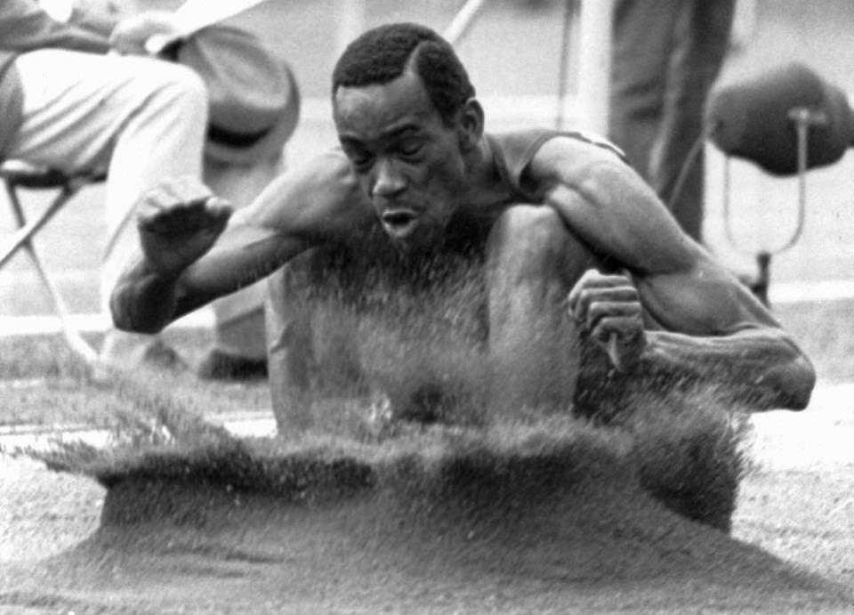 FILE - In this Oct. 18, 1968, file photo, Bob Beamon of El Paso, Texas, digs his feet into the sand pit after a record-shattering long jump of 8.90 meters on his first attempt at the Summer Olympic Games in Mexico City. (AP Photo/File)