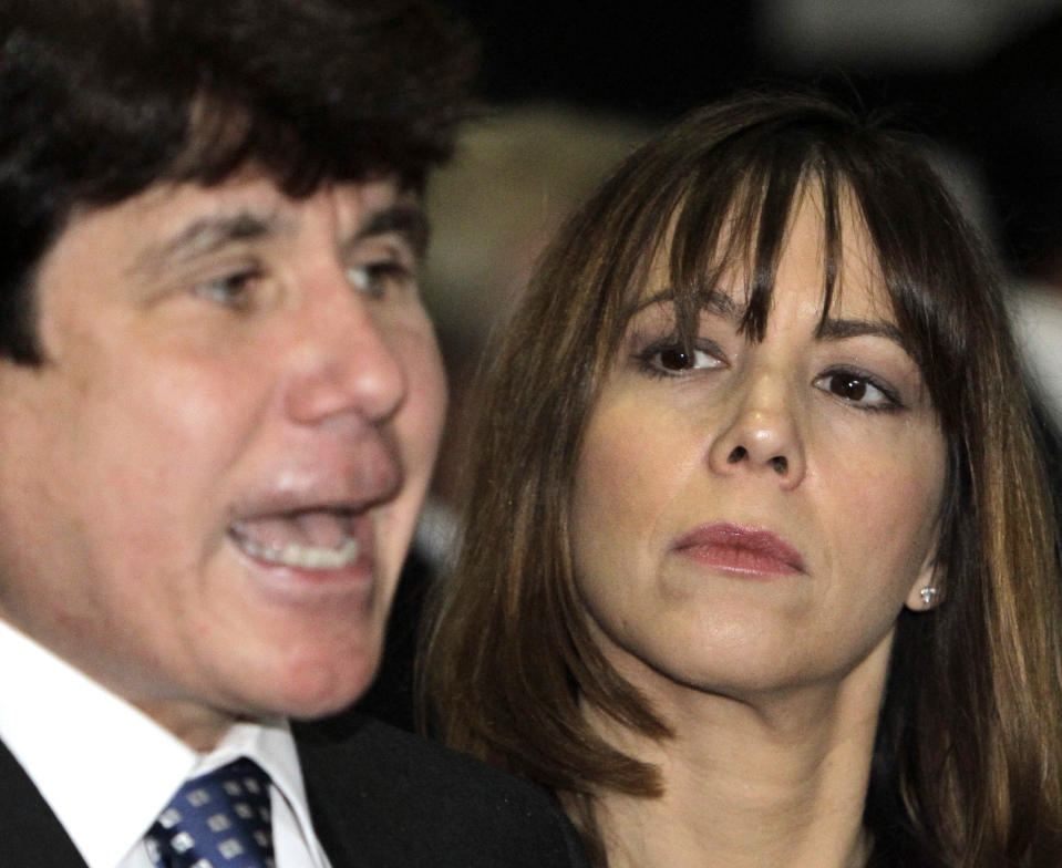 FILE - In this June 8, 2010, file photo, Patti Blagojevich, wife of former Illinois Gov. Rod Blagojevich, listens to her husband as they arrive at the federal courthouse for his corruption trial in Chicago. Patti Blagojevich made repeated public pleas for her husband’s release from federal prison. Her campaign began in 2018 soon after her husband lost a string of legal appeals that seemed to doom him to remain behind bars until his projected 2024 release date. (AP Photo/Charles Rex Arbogast, File)