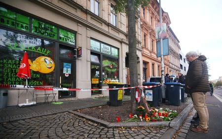 People are seen in front of a kebab shop in Halle