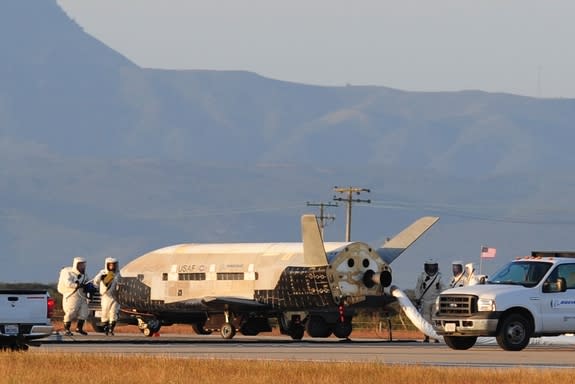 The Air Force's X-37B robotic space plane sits on the runway after landing at California's Vandenberg Air Force Base on June 16, 2012. The vehicle spent more than 15 months circling Earth on a mystery mission.