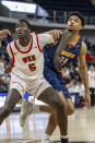 Western Kentucky forward Babacar Faye (5) and UTEP forward Kevin Kalu (34) battle for position under the basket during the first half of an NCAA college basketball game at the Conference USA Tournament final, Saturday, March 16, 2024, in Huntsville, Ala. (AP Photo/Vasha Hunt)