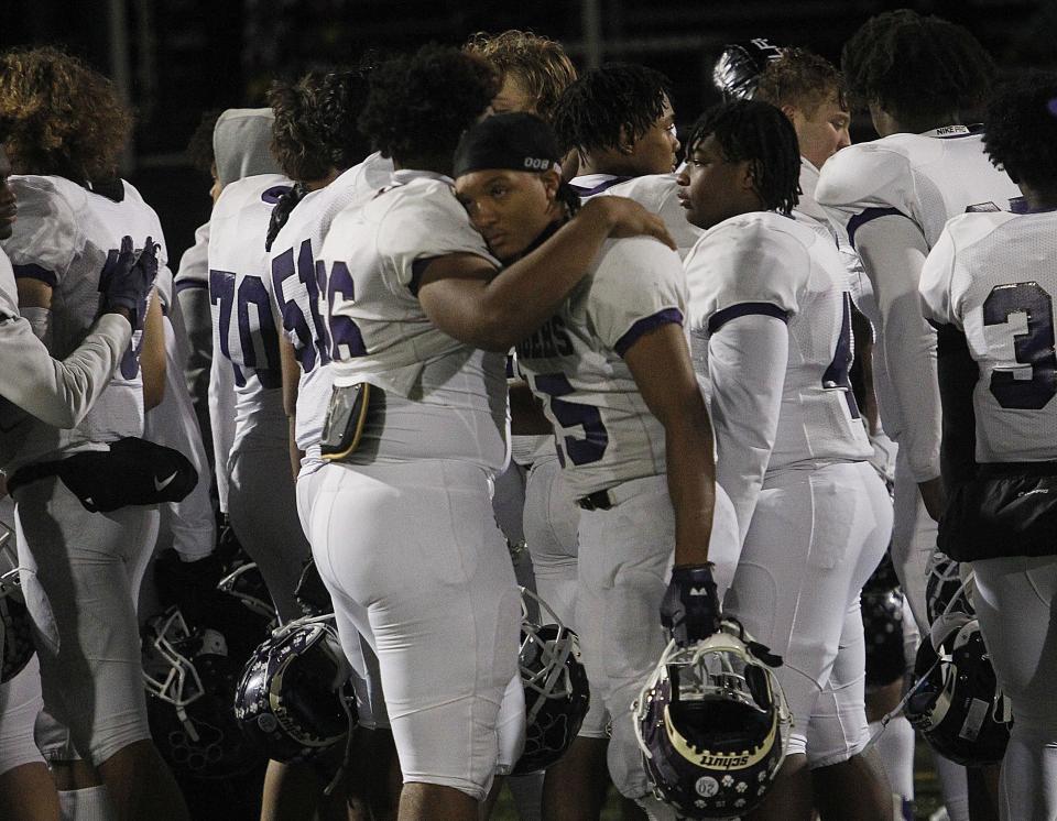 Pickerington Central's Dae'Yuan Thompson-Green and Troy Lane share a hug following the Tigers' 38-14 loss to Gahanna in the Division I Regional Semifinal game at DeSales on Nov. 11.  