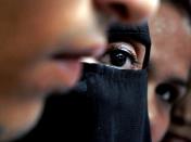 Ruwaida Usmani, center in black dress, waits to receive her husband Faiz Usmani's body outside a hospital in Mumbai, India, Sunday, July 17, 2011. Faiz Usmani, a man picked up by police for questioning in connection with Wednesday's blasts that killed 19 people and injured 130 others, died Sunday. Usmani's family has alleged that he was tortured during questioning. Police have denied the charge but an investigation has been ordered. (AP Photo/Rajanish Kakade)