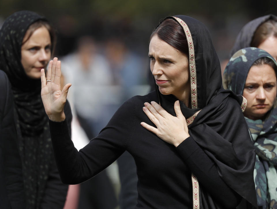 FILE - In this Friday, March 22, 2019 file photo, New Zealand Prime Minister Jacinda Ardern, center, waves as she leaves Friday prayers at Hagley Park in Christchurch, New Zealand. Ardern was hailed around the world for her decisive response to the two mosque shootings by a white nationalist who killed 50 worshippers. For many Muslims, her most consequential move was immediately labeling the attack an act of terrorism. Community leaders and researchers say that for too long, terrorism was considered a "Muslim problem" and that a double standard persists when attacker is white and non-Muslim. (AP Photo/Vincent Thian, File)