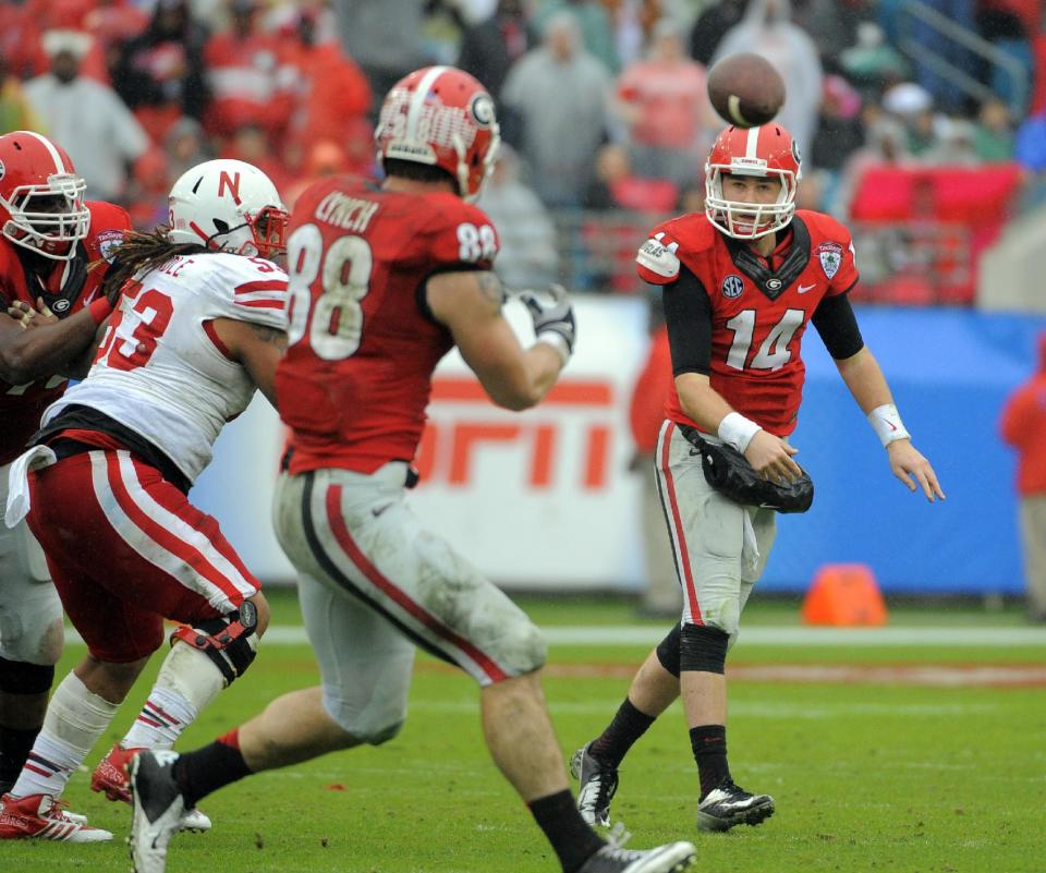 Georgia quarterback Hutson Mason (14) throws a pass to tight end Arthur Lynch (88) during the first half of the Gator Bowl NCAA college football game against Nebraska, Wednesday, Jan. 1, 2014, in Jacksonville, Fla. (AP Photo/Stephen B. Morton)