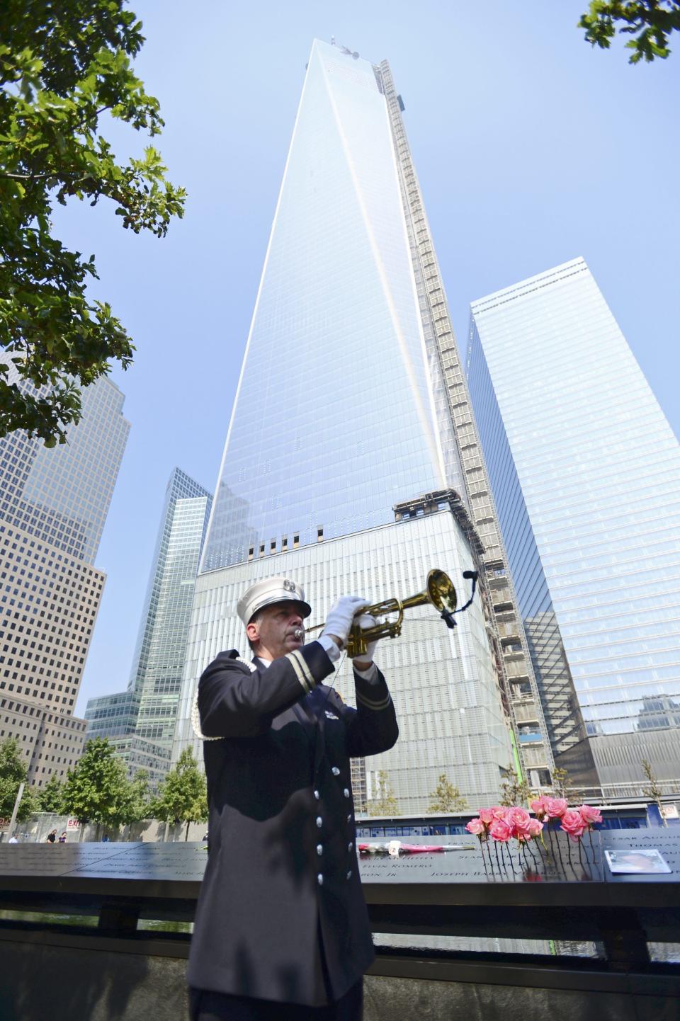 FDNY Captain Tom Engel plays taps at the 9/11 Memorial during ceremony marking the 12th Anniversary of the attacks on the World Trade Center in New York