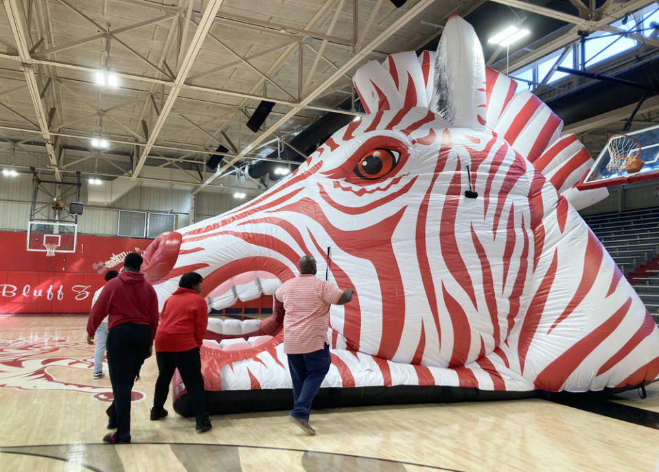 Students and staff inflate the Fighting Zebra mascot ahead of a college signing ceremony at Pine Bluff High School. (Jo Napolitano/The 74)