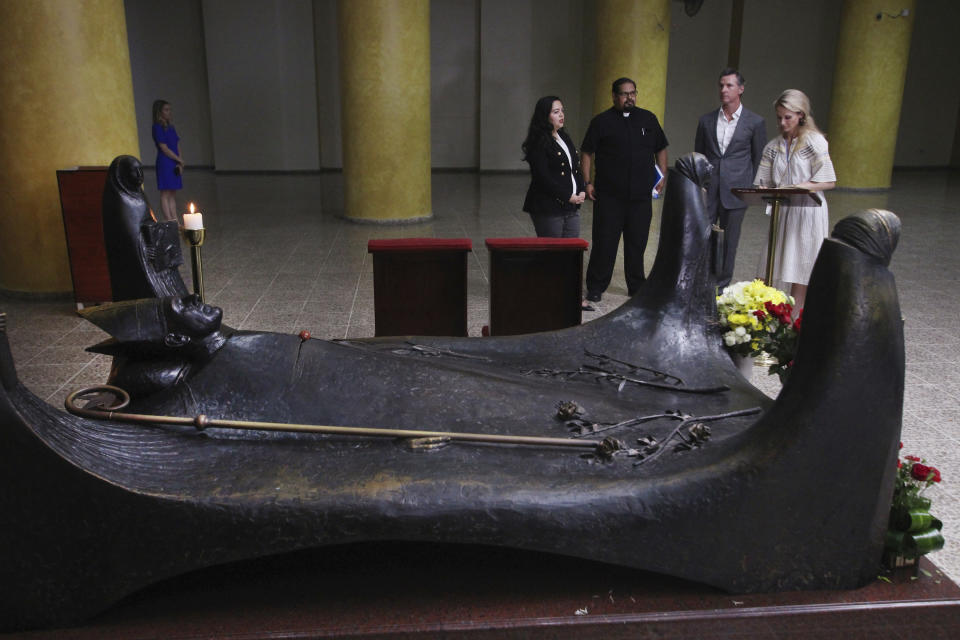 California Gov. Gavin Newsom, second right, and his wife, Jennifer Siebel Newsom, far right, visit the tomb of Archbishop Oscar Romero at Metropolitan Cathedral in San Salvador, El Salvador, Sunday, April 7, 2019. From left, California state Assemblywoman Wendy Carrillo, and father Francisco Villalobos. Newsom visited the tomb of Archbishop Romero, the Salvadoran priest assassinated in 1980 due to his advocacy for human rights and the poor. (AP Photo/Salvador Melendez, Pool)