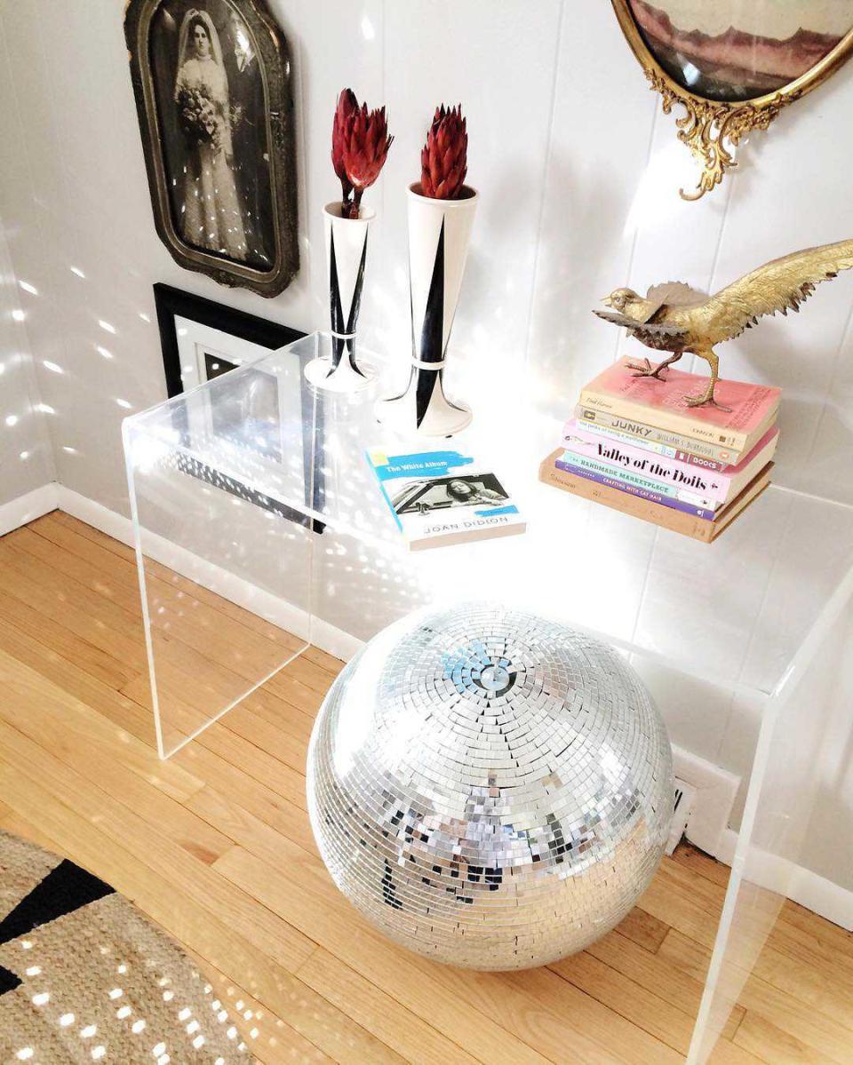 Large sculptural disco ball chair for a glass desk.