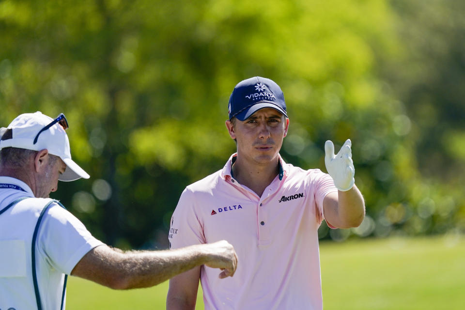 Carlos Ortiz, of Mexico, talks with his caddie at the 13th tee during the third round of the Mexico Open at Vidanta in Puerto Vallarta, Mexico, Saturday, April 30, 2022. (AP Photo/Eduardo Verdugo)