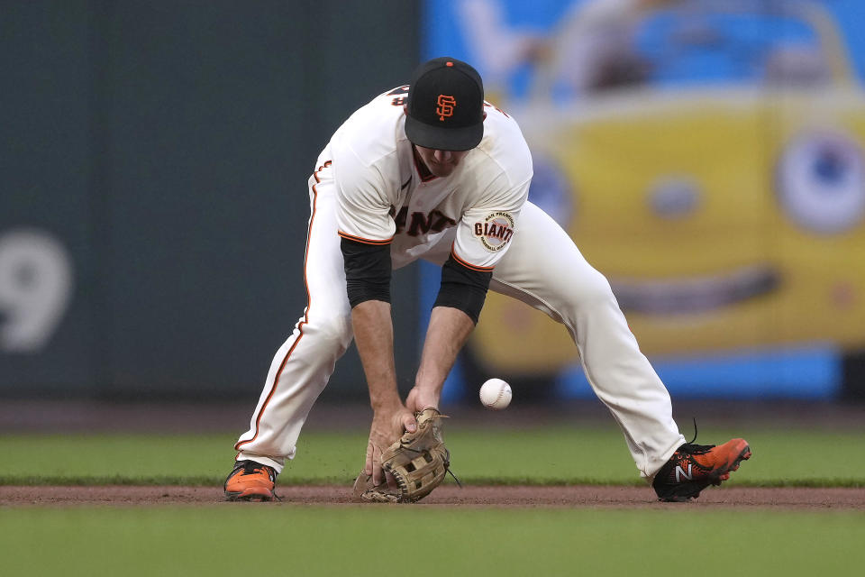 San Francisco Giants third baseman Jason Vosler can't make the stop on a grounder hit by Los Angeles Dodgers' Justin Turner during the fourth inning of a baseball game Wednesday, July 28, 2021, in San Francisco. Turner was safe at first. (AP Photo/Tony Avelar)