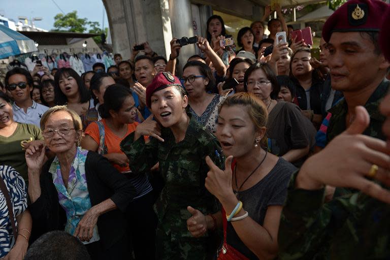 Soldiers dance with residents at a military event organised to 'return happiness to the people' at Victory Monument, the site of recent anti-coup rallies in Bangkok, on June 4, 2014