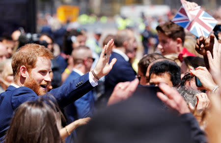 Britain's Prince Harry waves to members of the public during a visit at the Sydney Opera House in Sydney, Australia October 16, 2018. REUTERS/Phil Noble