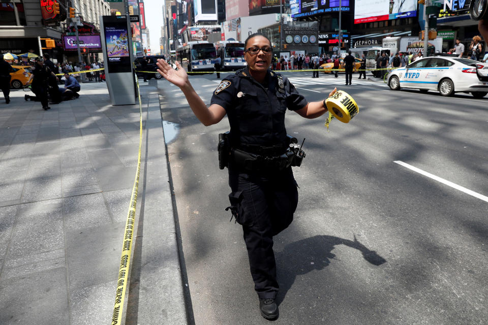 <p>A New York City Police (NYPD) officer motions people to get back in Times Square after a speeding vehicle struck pedestrians on the sidewalk in New York City on May 18, 2017. (Mike Segar/Reuters) </p>