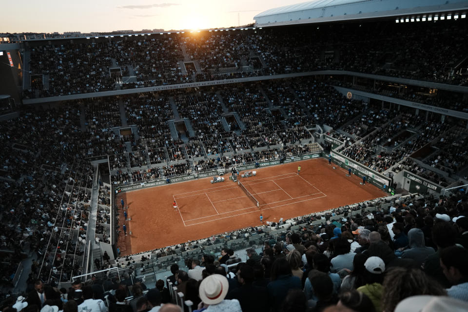 Spectators watch Serbia's Novak Djokovic playing Spain's Rafael Nadal during their quarterfinal match of the French Open tennis tournament at the Roland Garros stadium Tuesday, May 31, 2022 in Paris. (AP Photo/Thibault Camus)