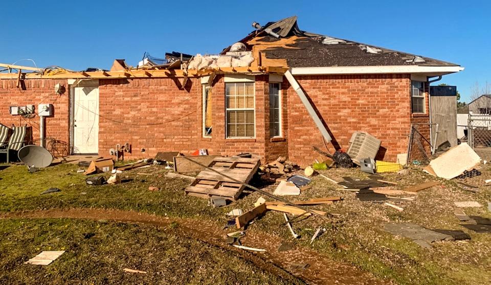 A damaged home is pictured Monday in Shawnee's Snider Heights neighborhood after Sunday night's tornado.