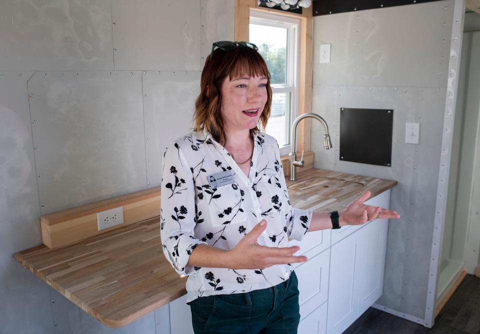 Emily Echevarria, communications director for the Council on Aging of West Florida, gives a tour of a tiny home on Monday. The organization purchased two of the units with a $50,000 grant from the AARP Community Challenge.