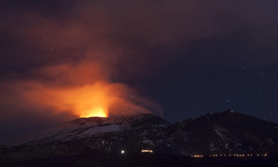 <p>Italy’s Mount Etna erupts, spewing out a bright orange cloud of volcanic lightning, cloud and ash. (PA)</p>