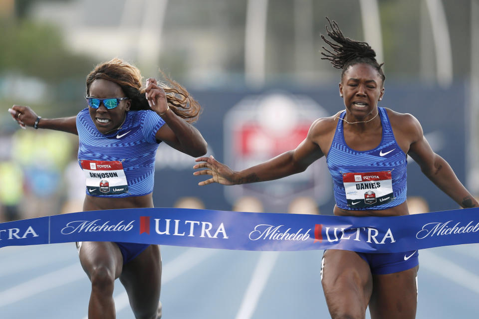 Teahna Daniels, right, beats Morolake Akinosun, left, to the finish line while winning the women's 100-meter dash at the U.S. Championships athletics meet, Friday, July 26, 2019, in Des Moines, Iowa. (AP Photo/Charlie Neibergall)