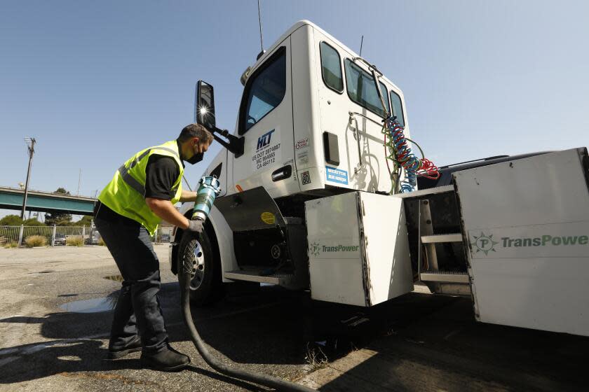 Wilmington, California-July 30, 2021-Total Transportation Services Inc. has one electric truck in its fleet at the Port of Los Angeles. Ryan Sickles is the terminal manager for heavy load transportation for Total Transportation Services Inc. He hooks up the electric supply to the truck. (Carolyn Cole / Los Angeles Times)