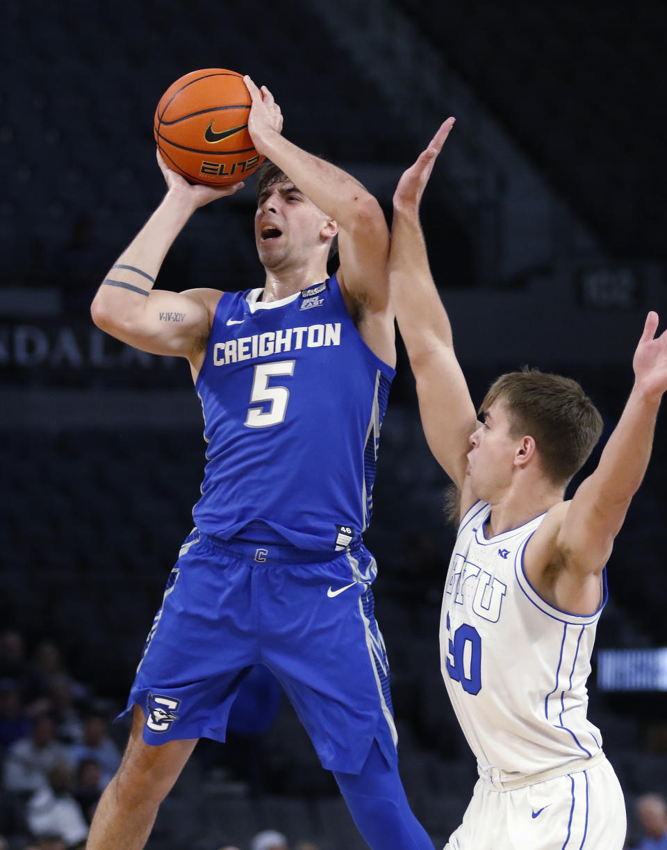 Creighton guard Francisco Farabello (5) goes up for a shot while BYU guard Dallin Hall (30) defends during the first half of an NCAA college basketball game Saturday, Dec. 10, 2022, in Las Vegas. (AP Photo/Ronda Churchill)