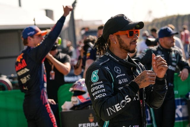 Max Verstappen (left) waves to the crowd after claiming pole position