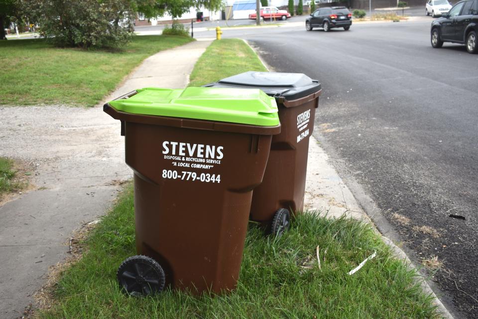 Two refuse totes provided by Stevens Disposal and Recycling Services, one for recycling and one for trash, are pictured Aug. 13, 2022, out at the curb of a residence on Division Street in Adrian. Stevens has asked Tecumseh about switching all residences to using totes.