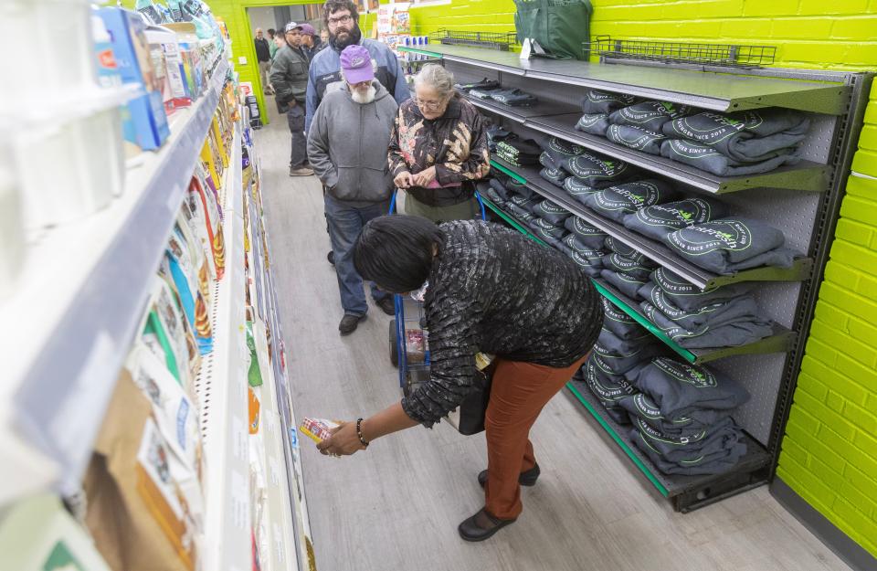 Shoppers peruse the shelves of the newly opened Stark Fresh grocery store in Alliance.