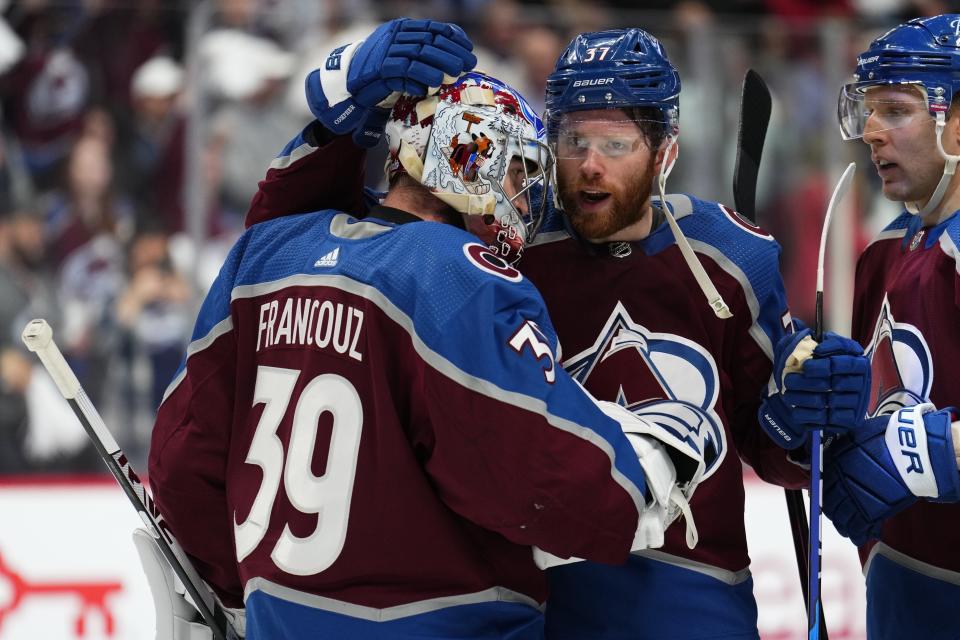 Colorado Avalanche left wing J.T. Compher (37) celebrates with goaltender Pavel Francouz (39) after the team's 8-6 win over the Edmonton Oilers in Game 1 of the NHL hockey Stanley Cup playoffs Western Conference finals Tuesday, May 31, 2022, in Denver. (AP Photo/Jack Dempsey)