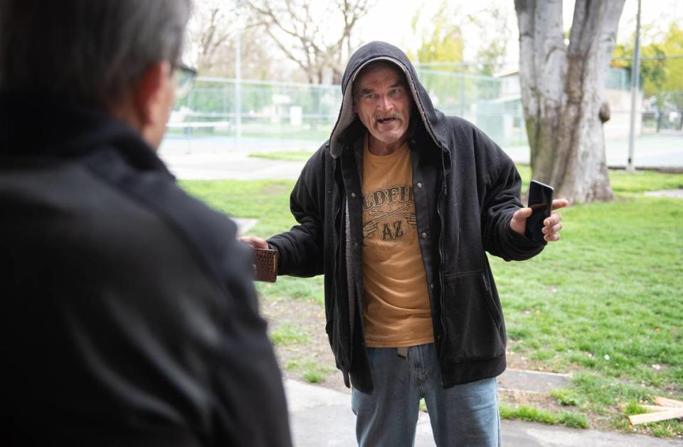 Homeless resident Kevin Walker talks with Modesto councilmember Nick Bavaro at Graceada Park in Modesto, Calif., Wednesday, March 29, 2023. Andy Alfaro/aalfaro@modbee.com